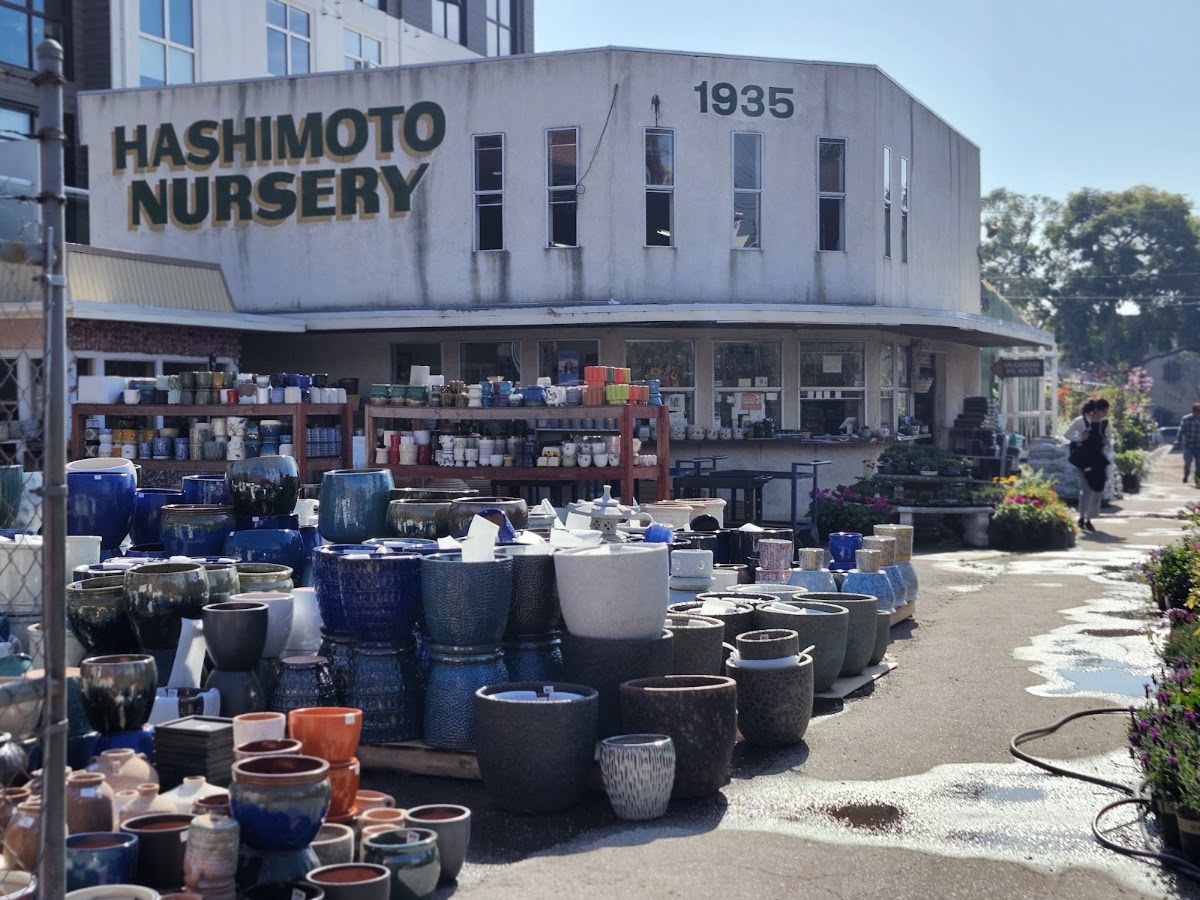Hashimoto Nursery at 1935 Sawtelle Blvd: the green-and-gold sign above rows of glazed ceramic pottery